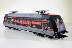 Trix H0 - Art. 25479 DB AG Locomotiva trax Classe 101 della Deutsche Bahn AG (DB AG). Con grafica pubblicitaria "100 anni della BR 01". Epoca VI - SOUND, Trix H0 - Art. 25479 DB AG Locomotiva trax Classe 101 della Deutsche Bahn AG (DB AG). Con grafica pubblicitaria "100 anni della BR 01". Epoca VI - SOUND E PANTOGRAFI MOBILI
Modello con decoder digitale e ampie funzioni sonore. Motorizzazione ad alta efficienza controllata. 4 assi azionati. Cerchioni di aderenza. I fanali direzionali a tre fanali e due luci di posizione rosse funzionano in modo convenzionale; commutabili digitalmente. Gli abbaglianti possono essere commutati separatamente. L'illuminazione della cabina di guida può essere commutata digitalmente. I fanali di testa sulle testate 1 e 2 della locomotiva possono essere disattivati ​​separatamente. Quando i fanali di testa sono spenti su entrambe le testate, la funzione di luce a doppia A viene attivata su entrambe le testate. Illuminazione con LED a luce bianca calda e rossi esenti da manutenzione. Con accumulatore di energia per compensare brevi interruzioni di corrente. Meccanismo di aggancio corto. Lunghezza ai respingenti 21,9 cm.